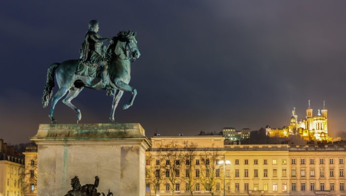 statue in lyon's bellcour place at night