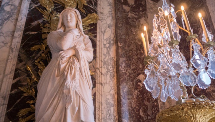 chandelier and statue of woman in Versaille